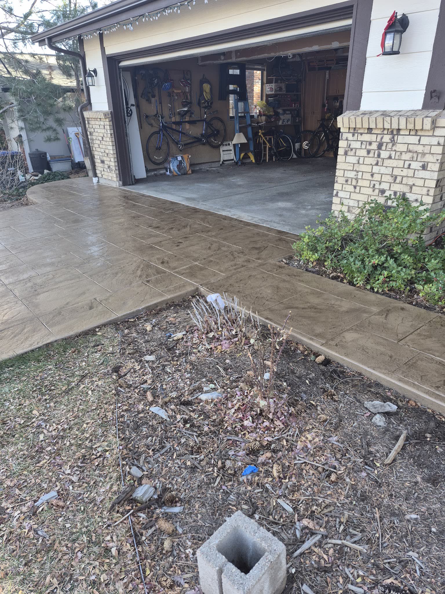 Stamped concrete driveway apron running up to an open garage